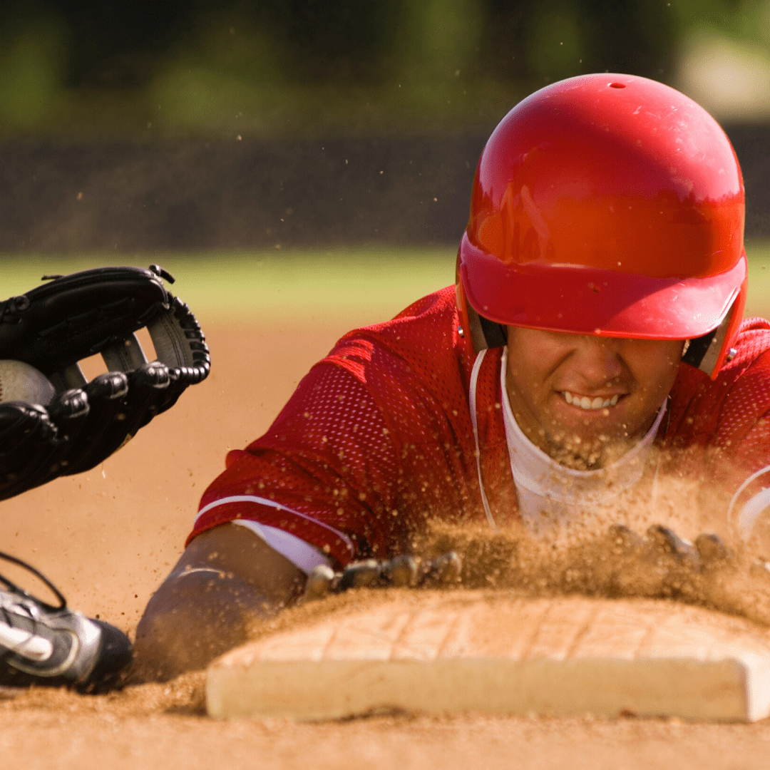 A baseball player sliding into the base