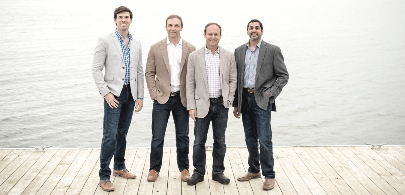 A group of men standing on top of a dock.