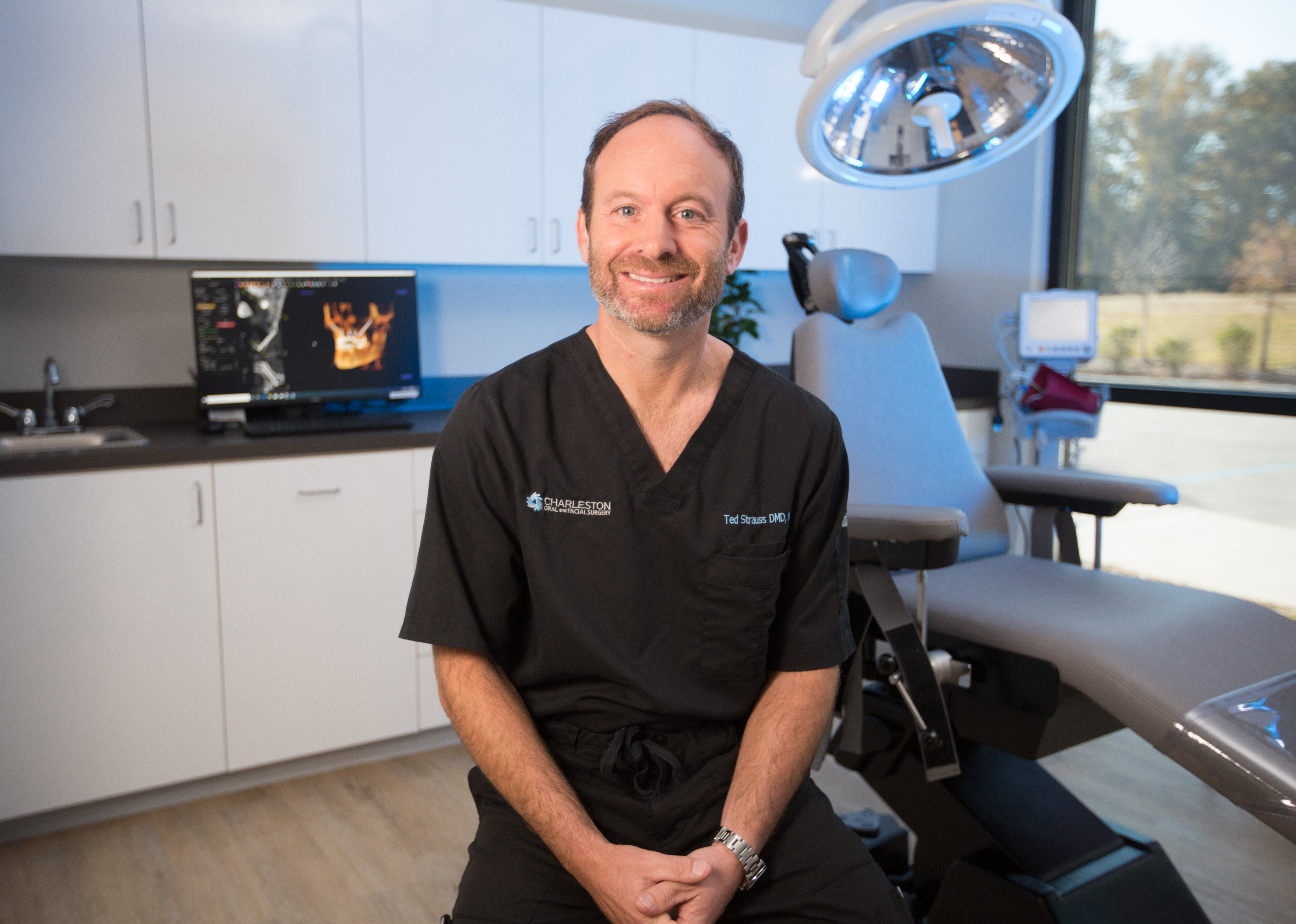 A man sitting in front of an operating room.